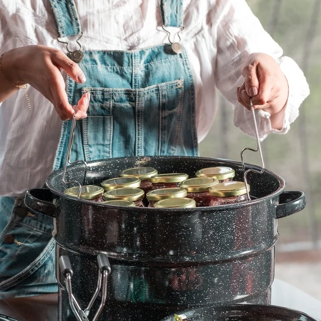 A cook lifting a canning rack