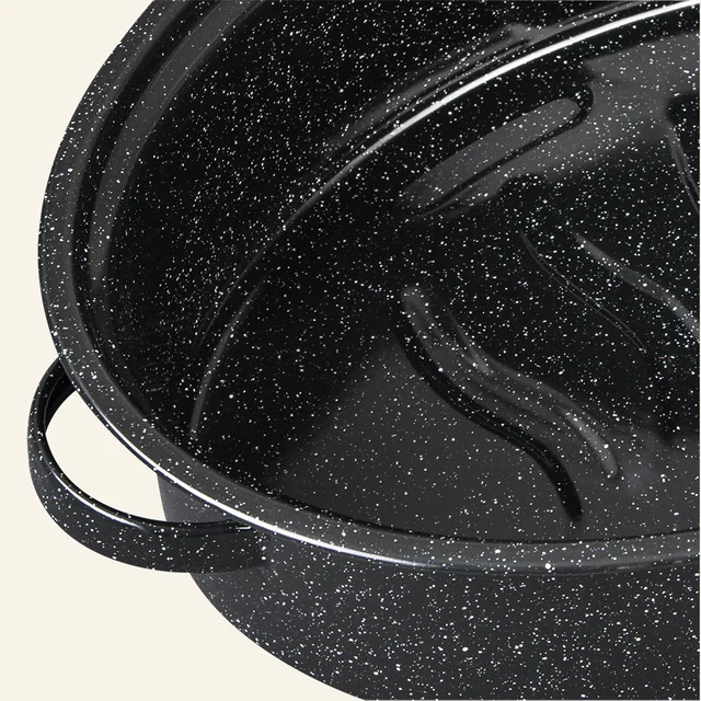 Close detail of the black speckled enamel surface