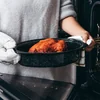 Carrying the roaster with oven mitts